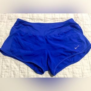 Dark purple/blue running Nike shorts.